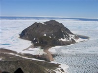 Aerial photo of the Kap Höegh showing location of the cabin and the Little Auk colony (the stripe of pale rock on the steep slope).